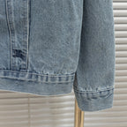 Denim jacket hem and cuff close-up with stitched edge and button detail
