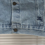 Denim jacket lower front close-up with bottom button and flap-pocket seams
