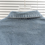 Light blue denim jacket collar with top seam details