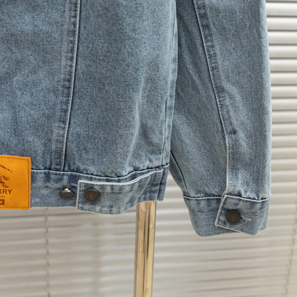 Light blue denim jacket sleeve cuff with button tabs and stitching