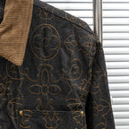 Louis Vuitton long denim jacket side detail with tan corduroy collar and gold pattern