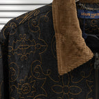 Louis Vuitton denim jacket shoulder detail with tan corduroy collar and gold pattern