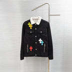Black denim jacket with white sherpa collar and multicolor cross patches