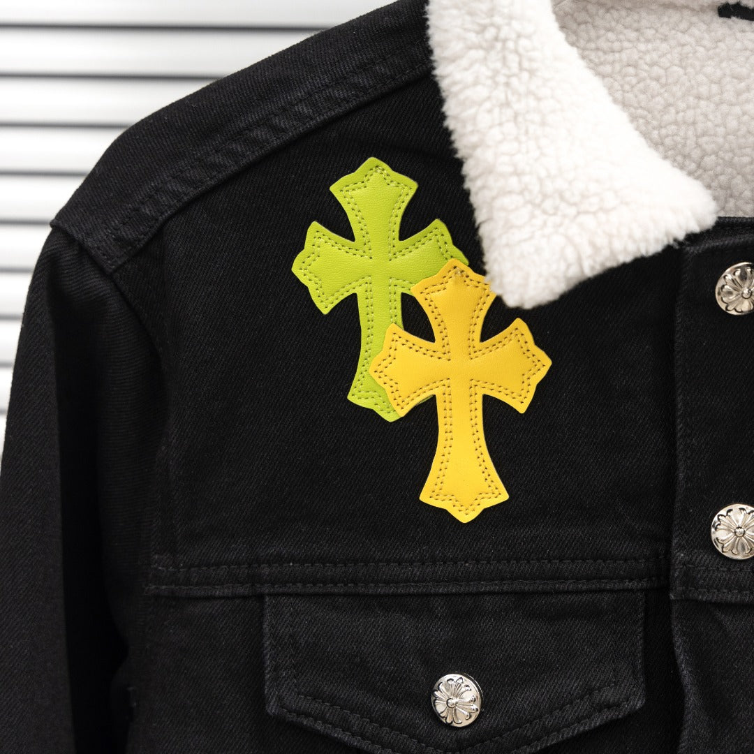 Black denim jacket shoulder with yellow cross patch and snap-button placket
