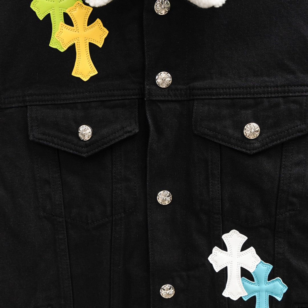 Black denim jacket front with silver snap buttons and cross patches