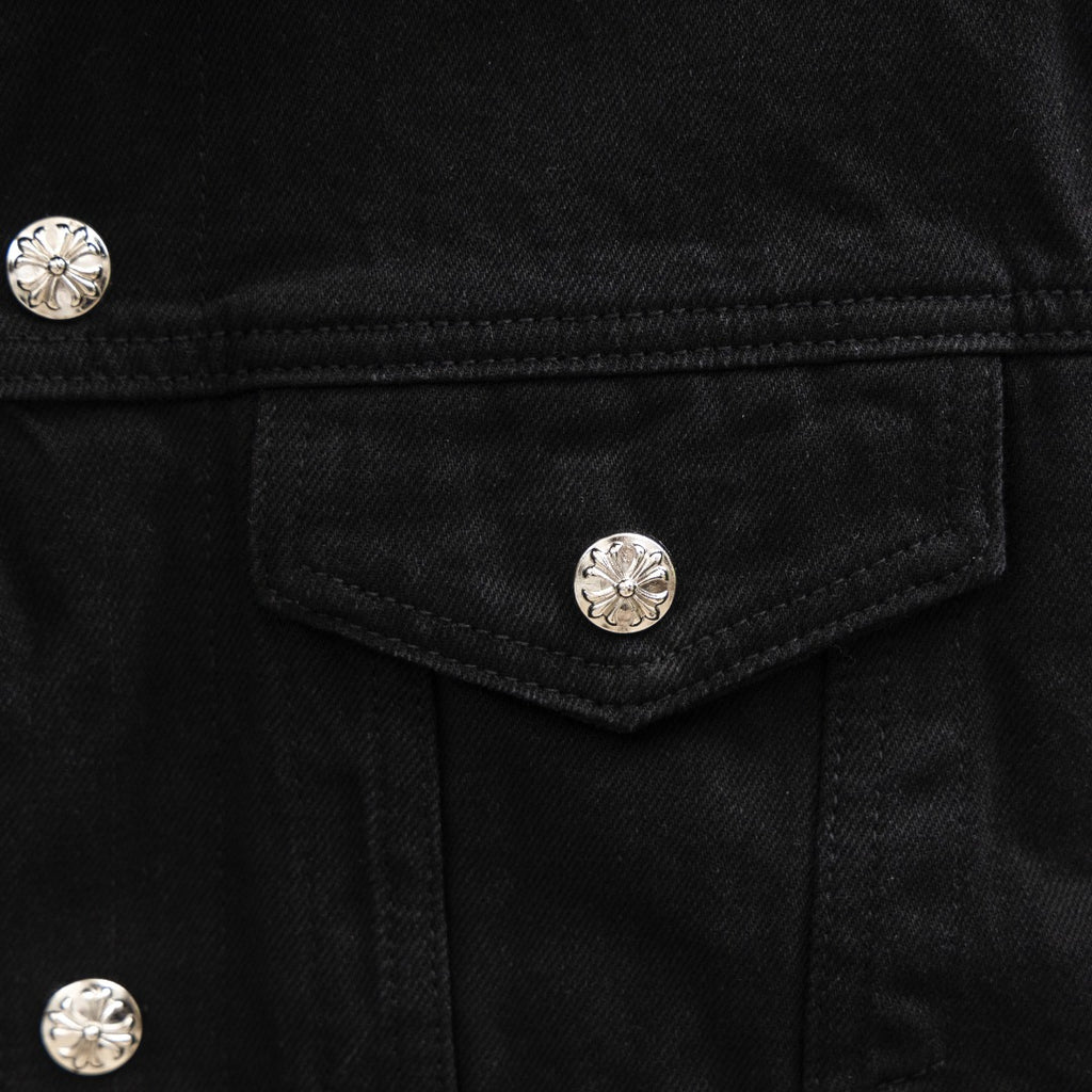 Black denim jacket chest pocket with silver snap button detail