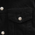 Black denim jacket chest pocket with silver snap button detail