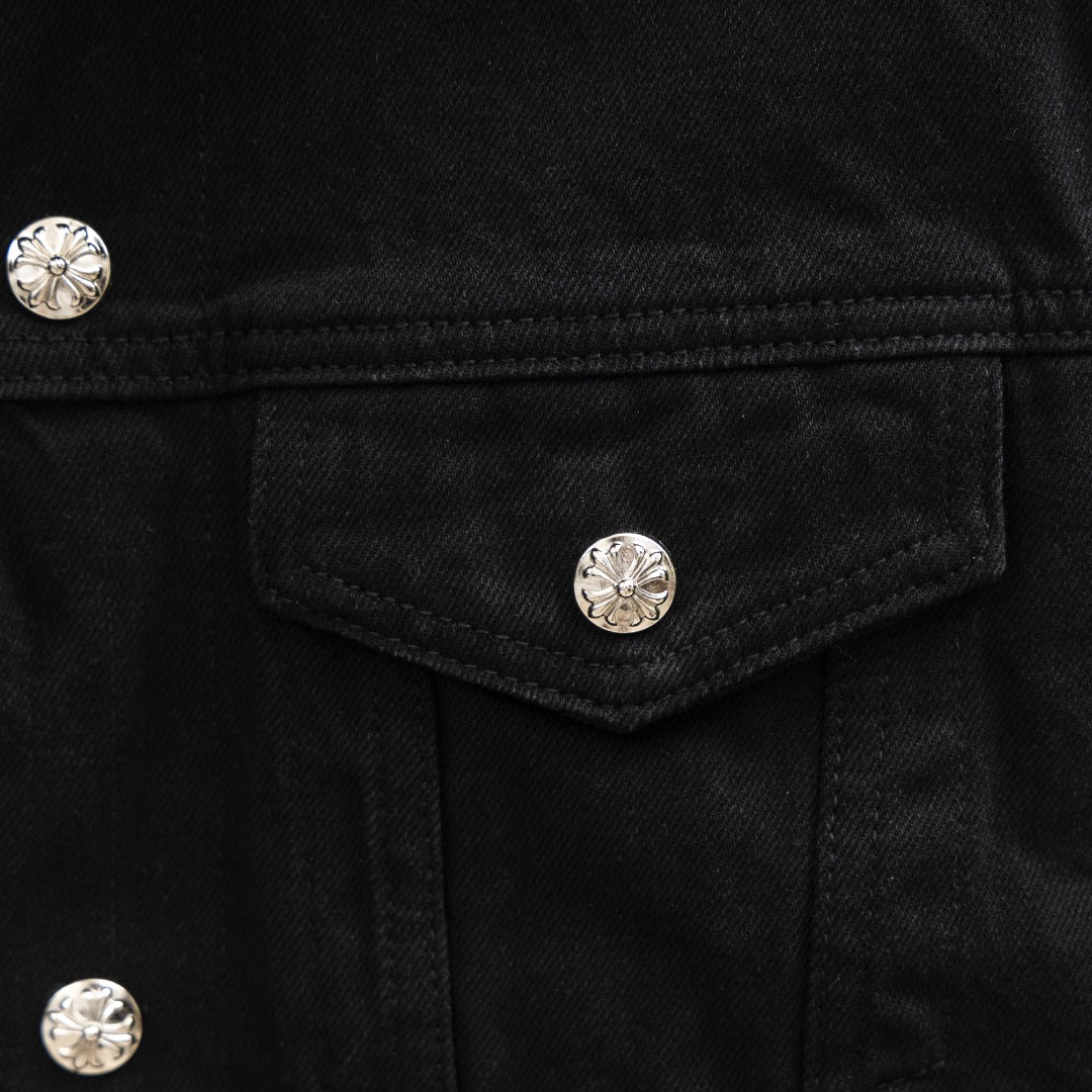 Black denim jacket chest pocket with silver snap button detail