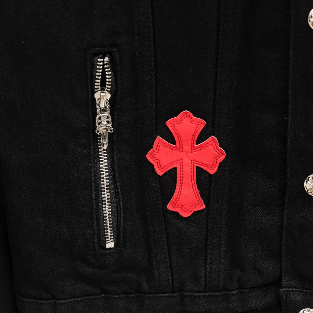 Black denim jacket with red cross patch and front zipper panel