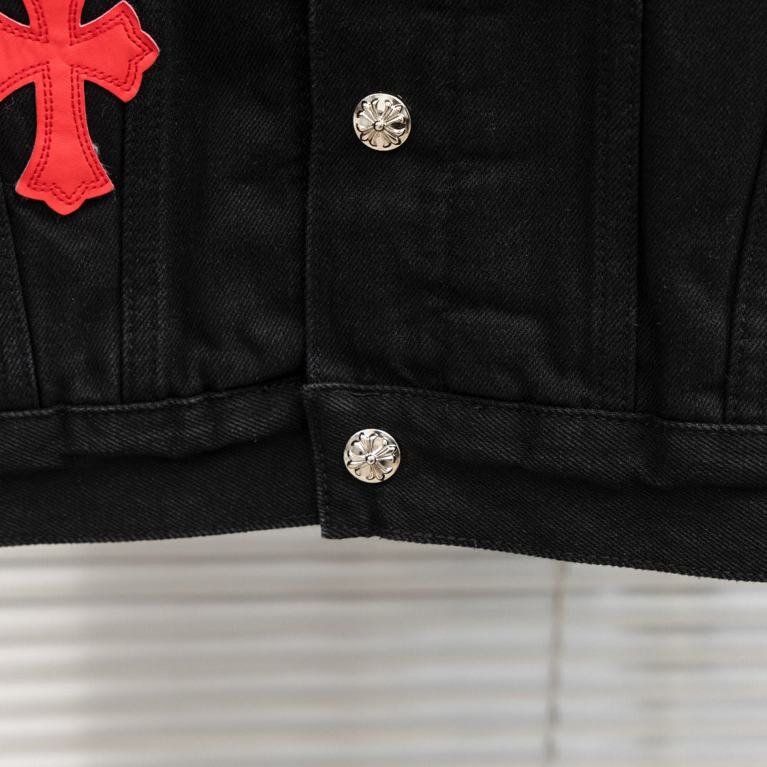 Black denim jacket with red cross patch on left chest