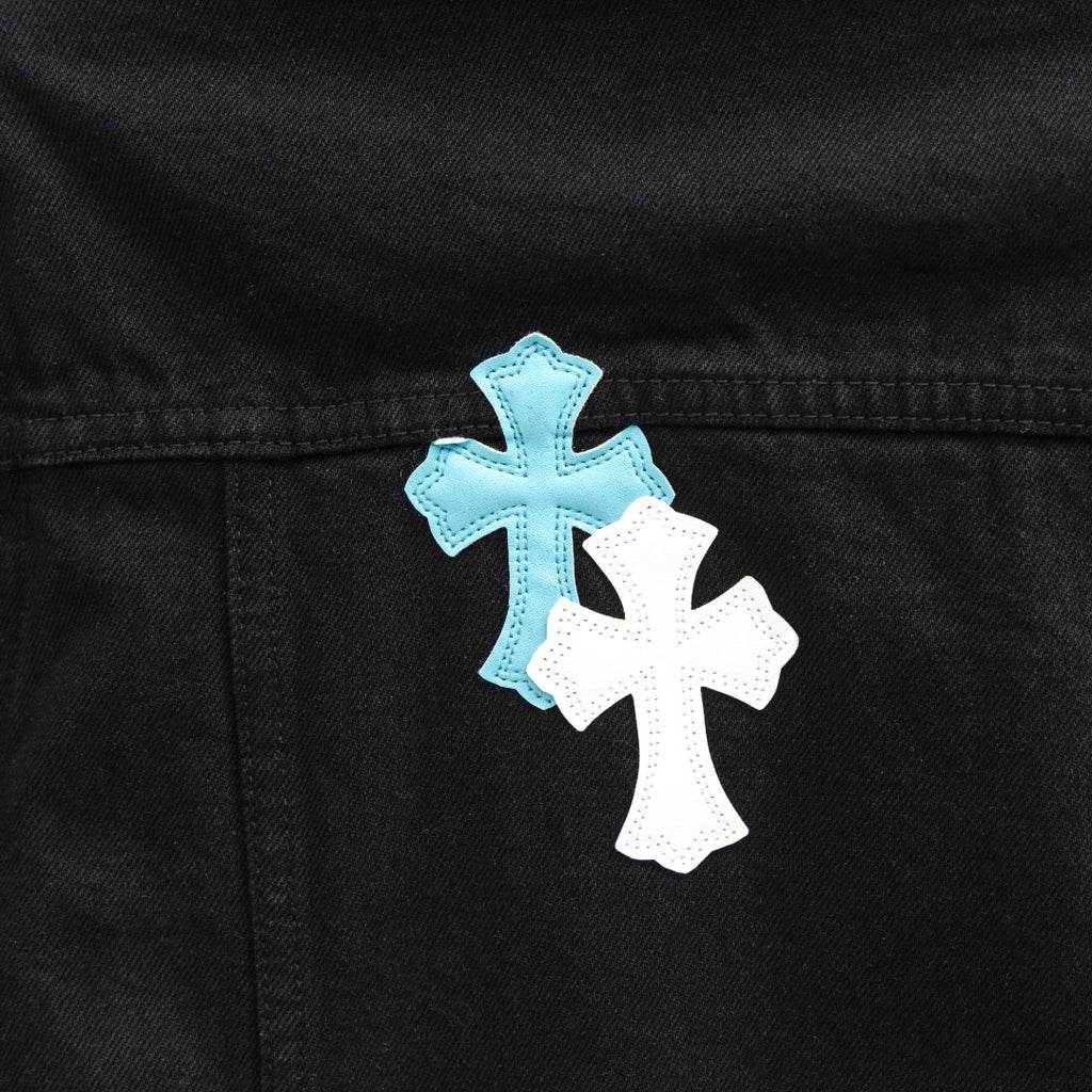 Black denim jacket front panel with blue and white cross patch