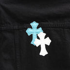 Black denim jacket front panel with blue and white cross patch