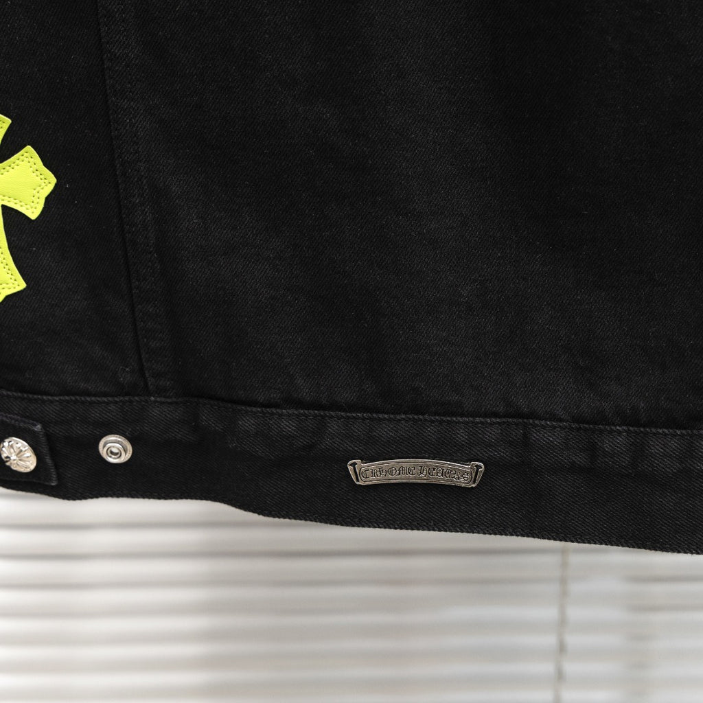 Black denim jacket hem with metal buttons and inner brand label