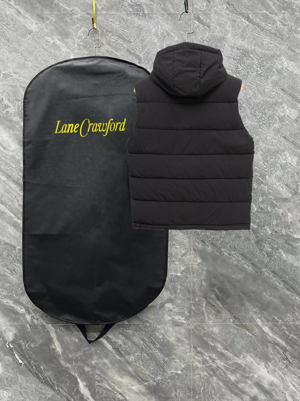 Black long padded vest with hood and horizontal quilting