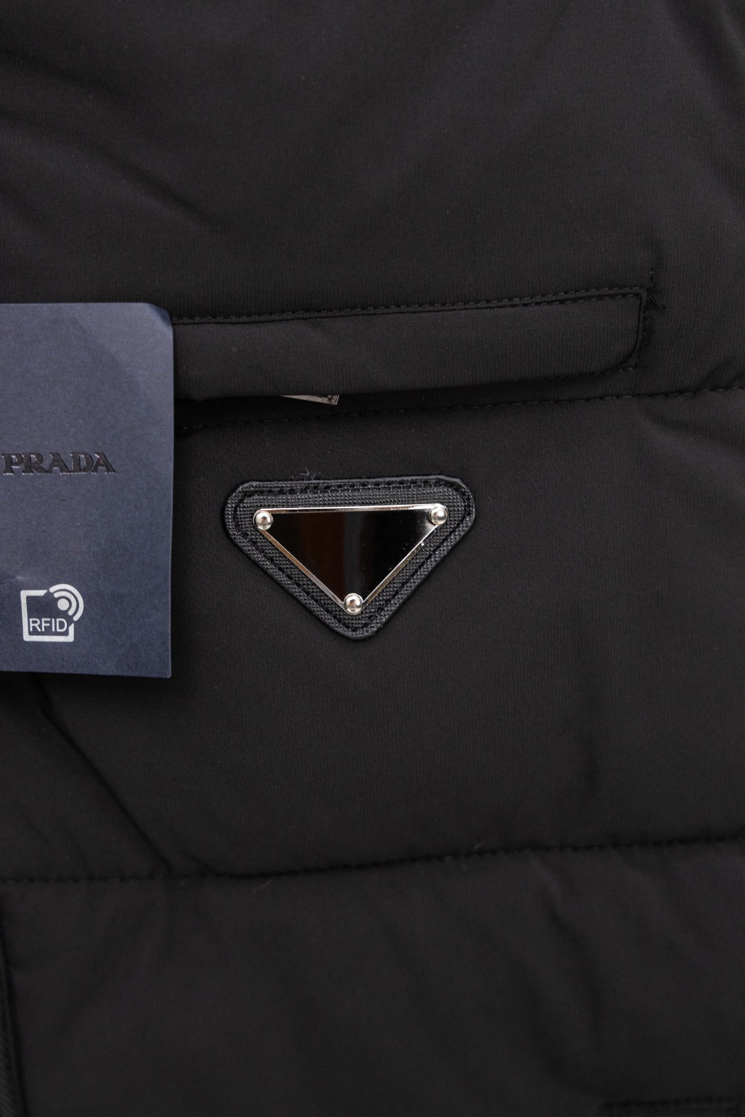 Black padded vest chest triangle metal logo and zipper placket