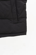 Black long padded vest hem with vertical quilt seams