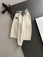 Cream long-sleeve sweater on hanger with light blue collar and Dior logo