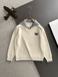 Cream long-sleeve sweater with light blue collar and embroidered Dior logo