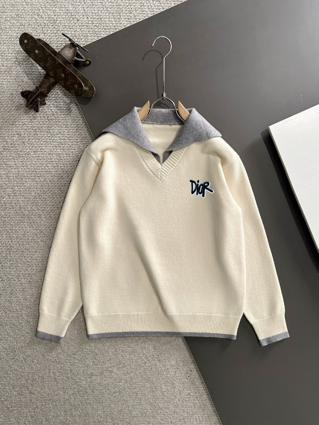 Cream long-sleeve sweater with light blue collar and embroidered Dior logo