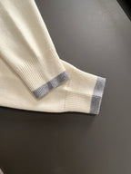 Cream sweater cuff with light blue ribbed trim on long sleeve