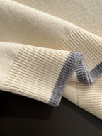 Cream knit fabric with light blue ribbed cuff detail