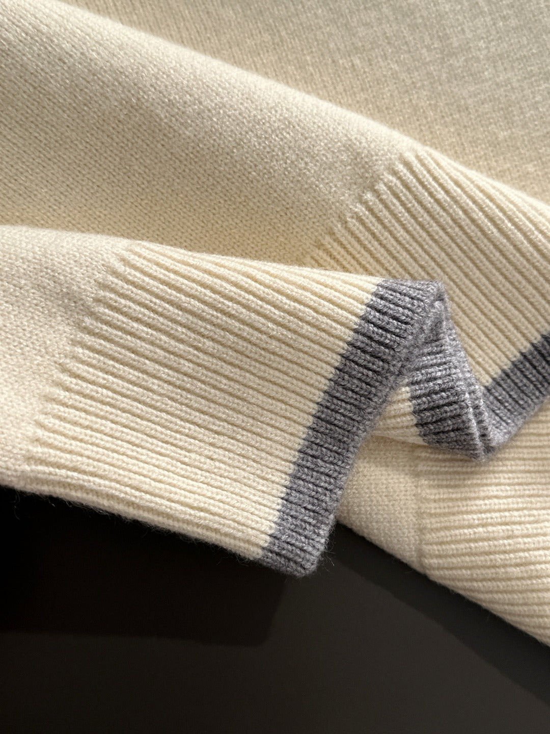 Cream knit fabric with light blue ribbed cuff detail