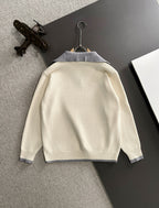 Cream sweater back with light blue collar trim and long sleeves