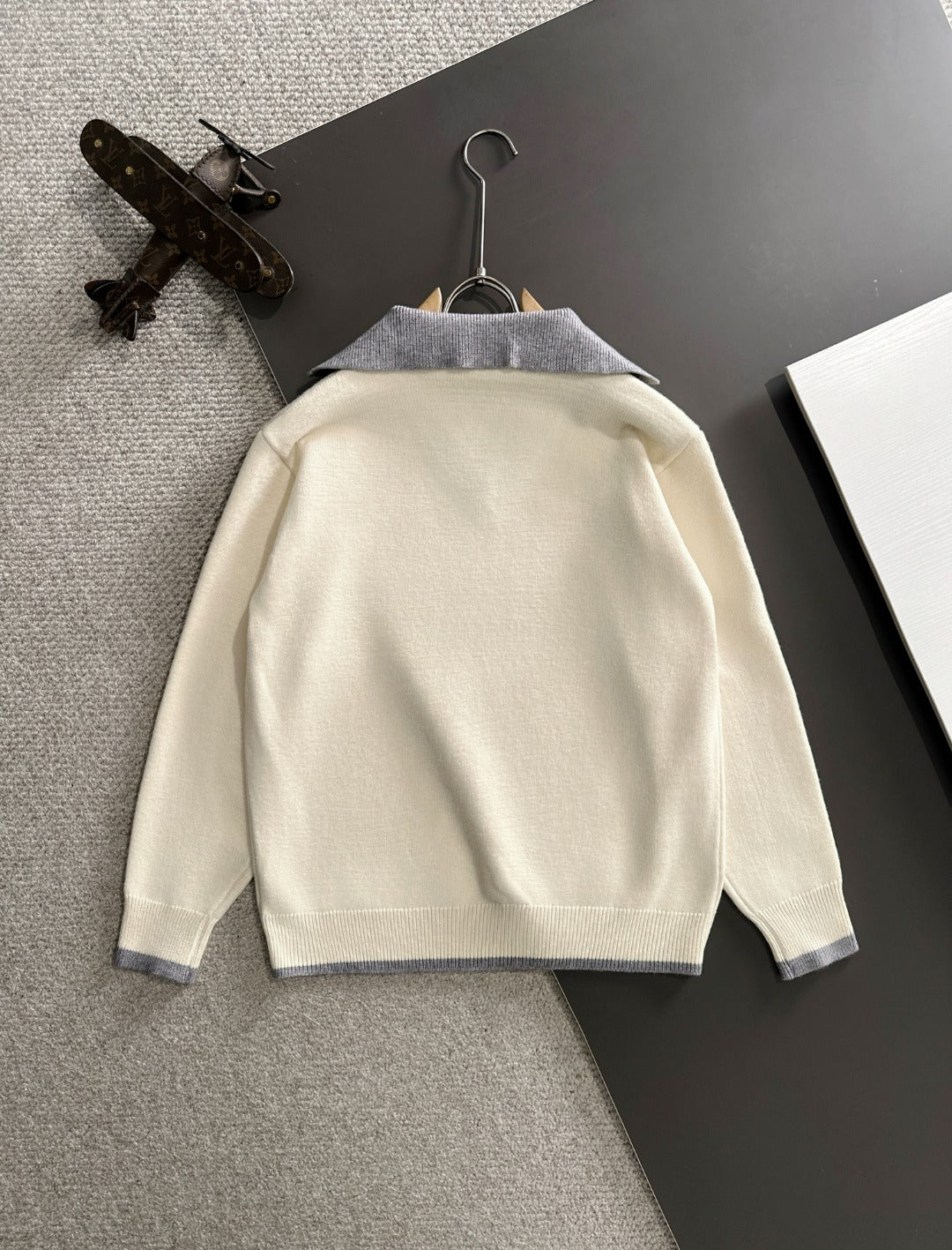 Cream sweater back with light blue collar trim and long sleeves