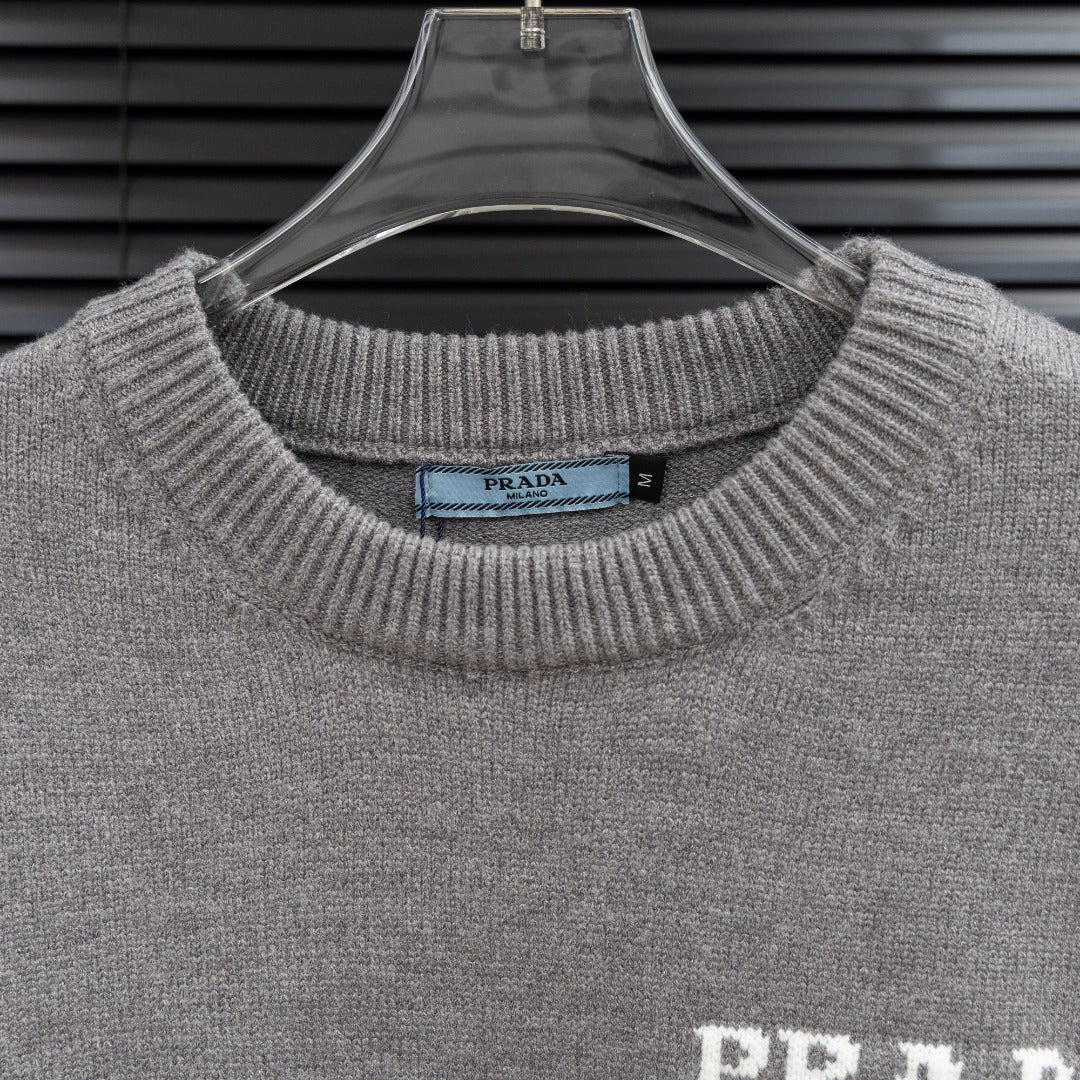 Prada knit sweater collar and PRADA Milano logo on heather gray fabric.