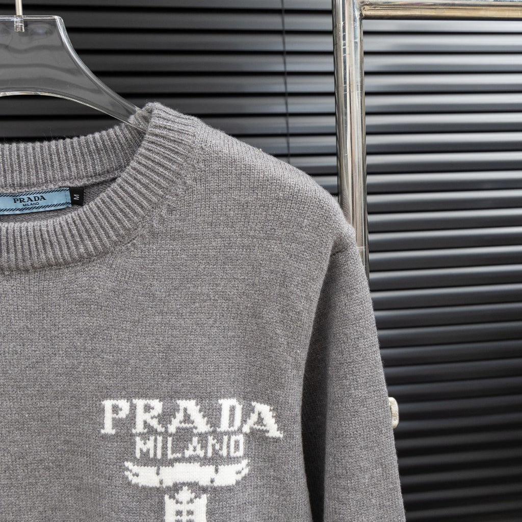 Prada heather gray sweater sleeve detail with PRADA Milano graphic on the front.