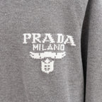 PRADA Milano logo on heather gray Prada knit sweater, with embroidered-style graphic.
