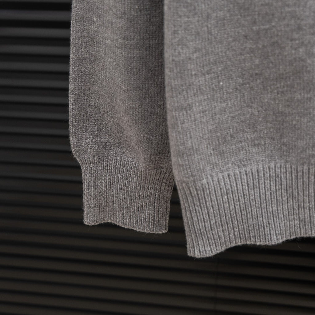 Prada heather gray sweater hem with ribbed knit cuff and sleeve end detail.