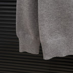 Prada heather gray sweater hem with ribbed knit cuff and sleeve end detail.