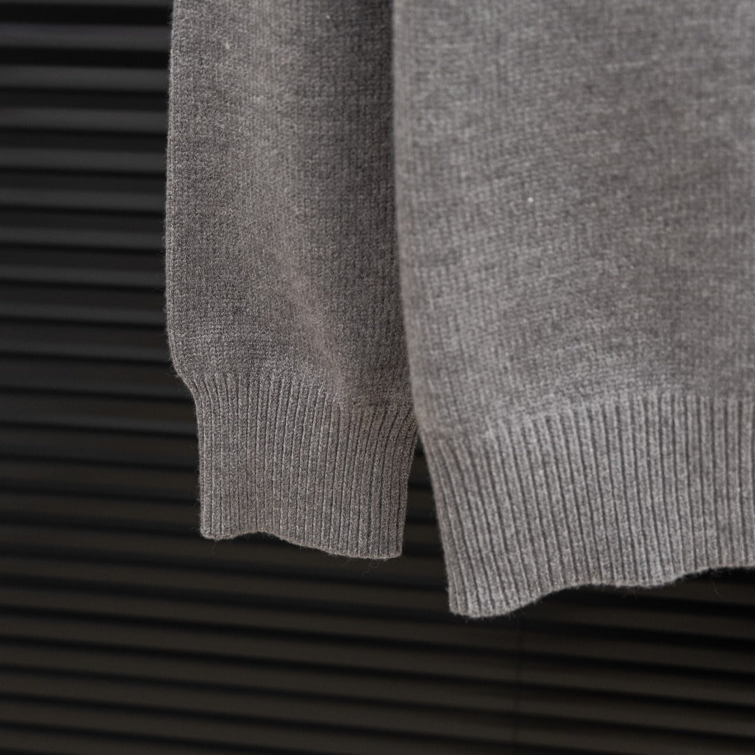 Prada heather gray sweater hem with ribbed knit cuff and sleeve end detail.