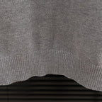 Prada heather gray sweater ribbed hem edge detail on knit fabric.