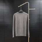 Prada long-sleeve sweater in heather gray with crew neck and ribbed cuffs.