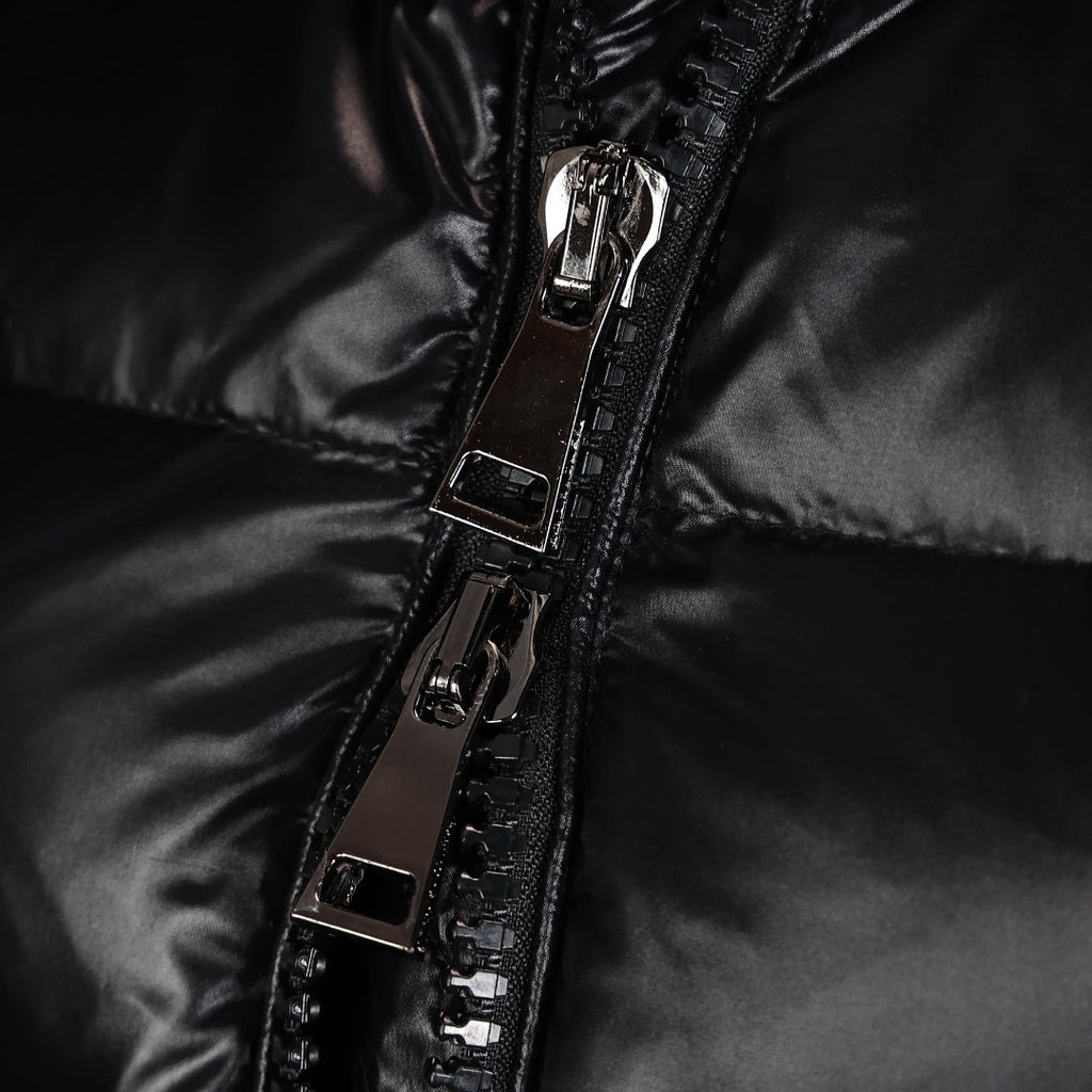 Front zipper and metal pull on black puffer coat, with stitched panel details