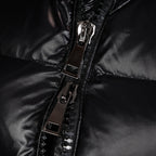 Front zipper and metal pull on black puffer coat, with stitched panel details