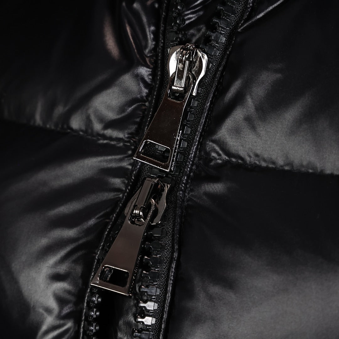 Front zipper and metal pull on black puffer coat, with stitched panel details