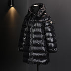 Long puffer coat with hood and front zipper; quilted black shell with side logo patch