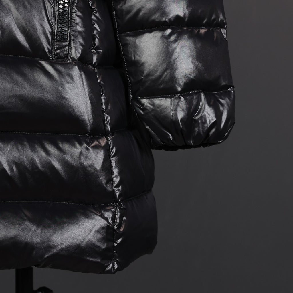 Black puffer coat sleeve cuff and lower pocket area with quilted baffles