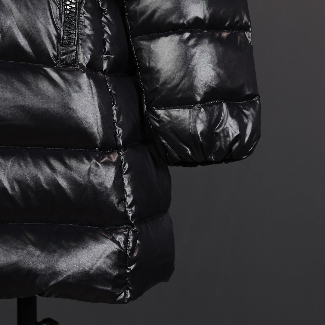 Black puffer coat sleeve cuff and lower pocket area with quilted baffles