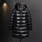 Long puffer coat with attached hood; horizontal quilted baffles and shiny black fabric
