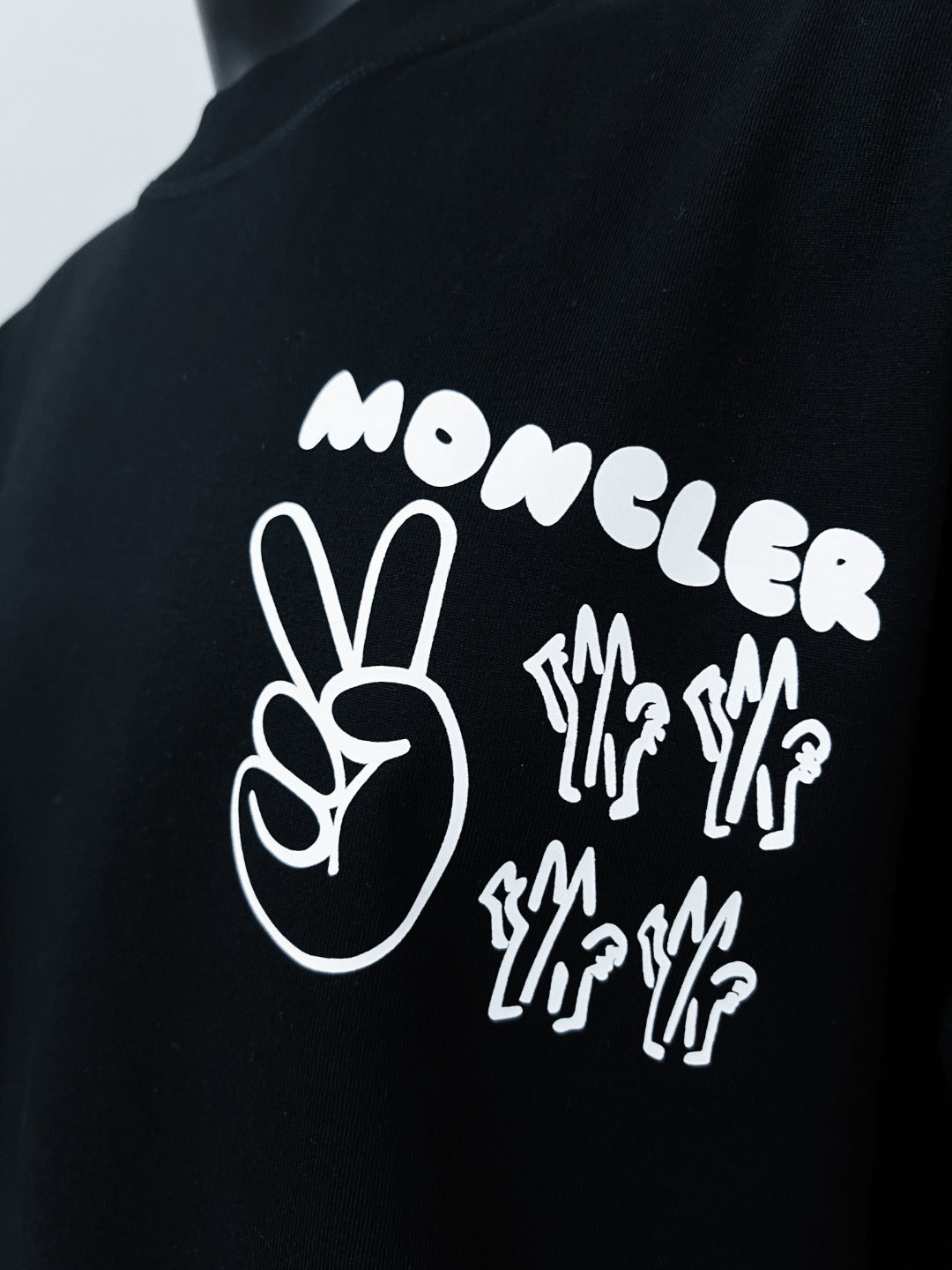 White Moncler hand and word graphic on dark navy short-sleeve T-shirt