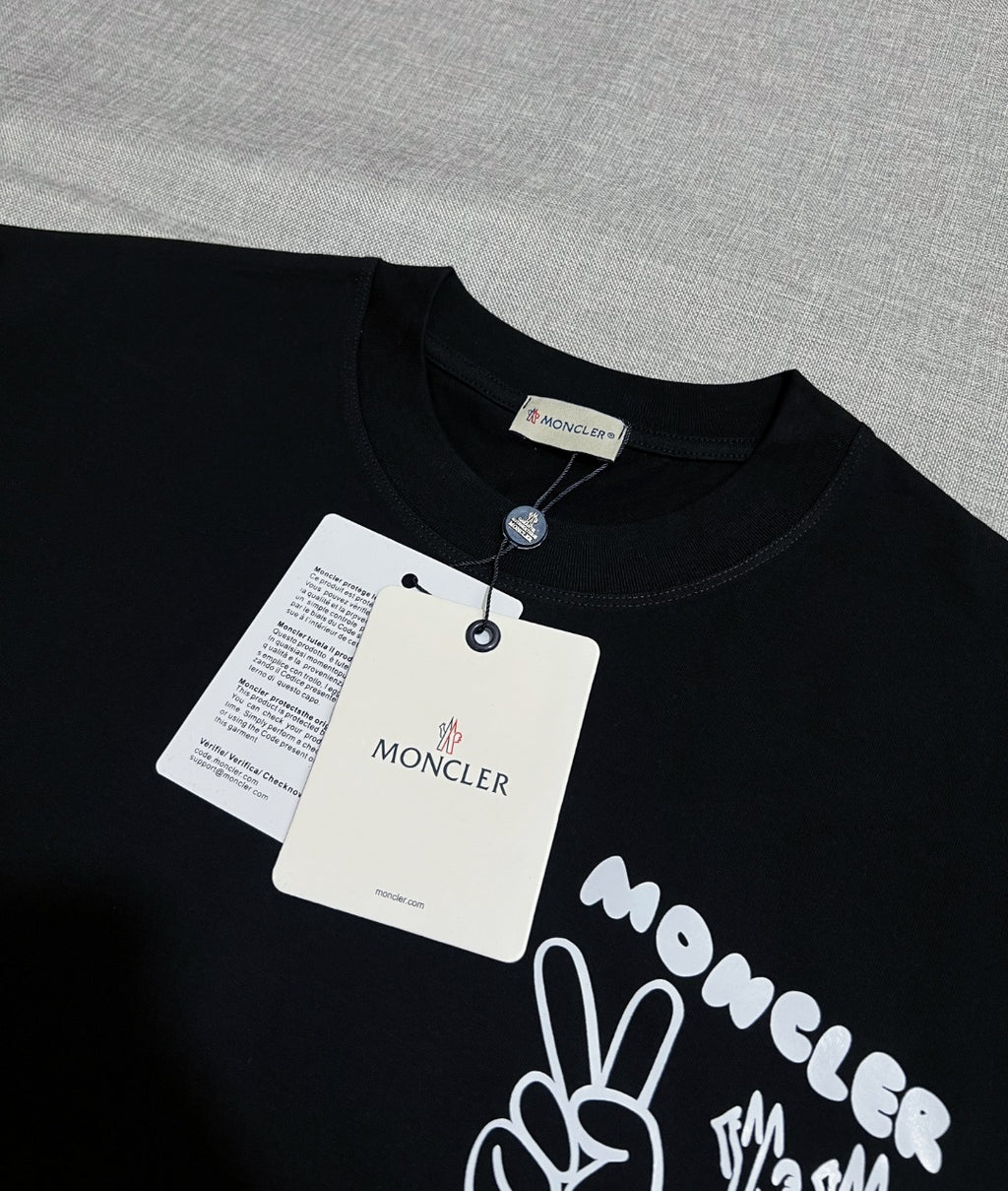 Dark navy short-sleeve T-shirt with neck label and Moncler graphic