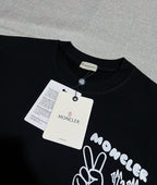Dark navy short-sleeve T-shirt with neck label and Moncler graphic