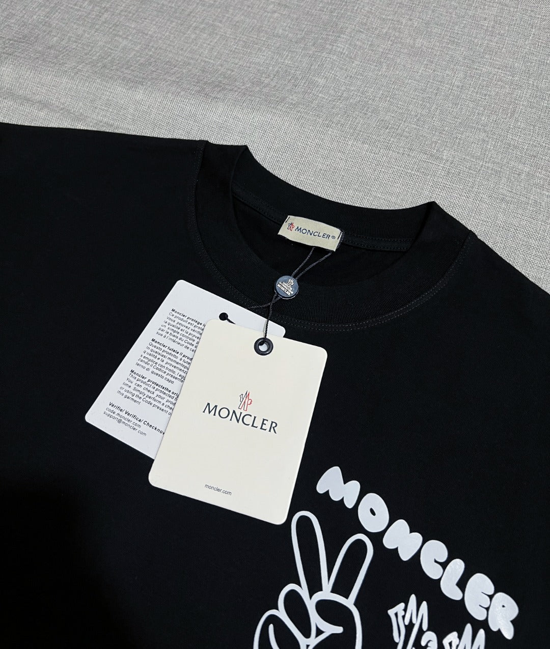 Dark navy short-sleeve T-shirt with neck label and Moncler graphic