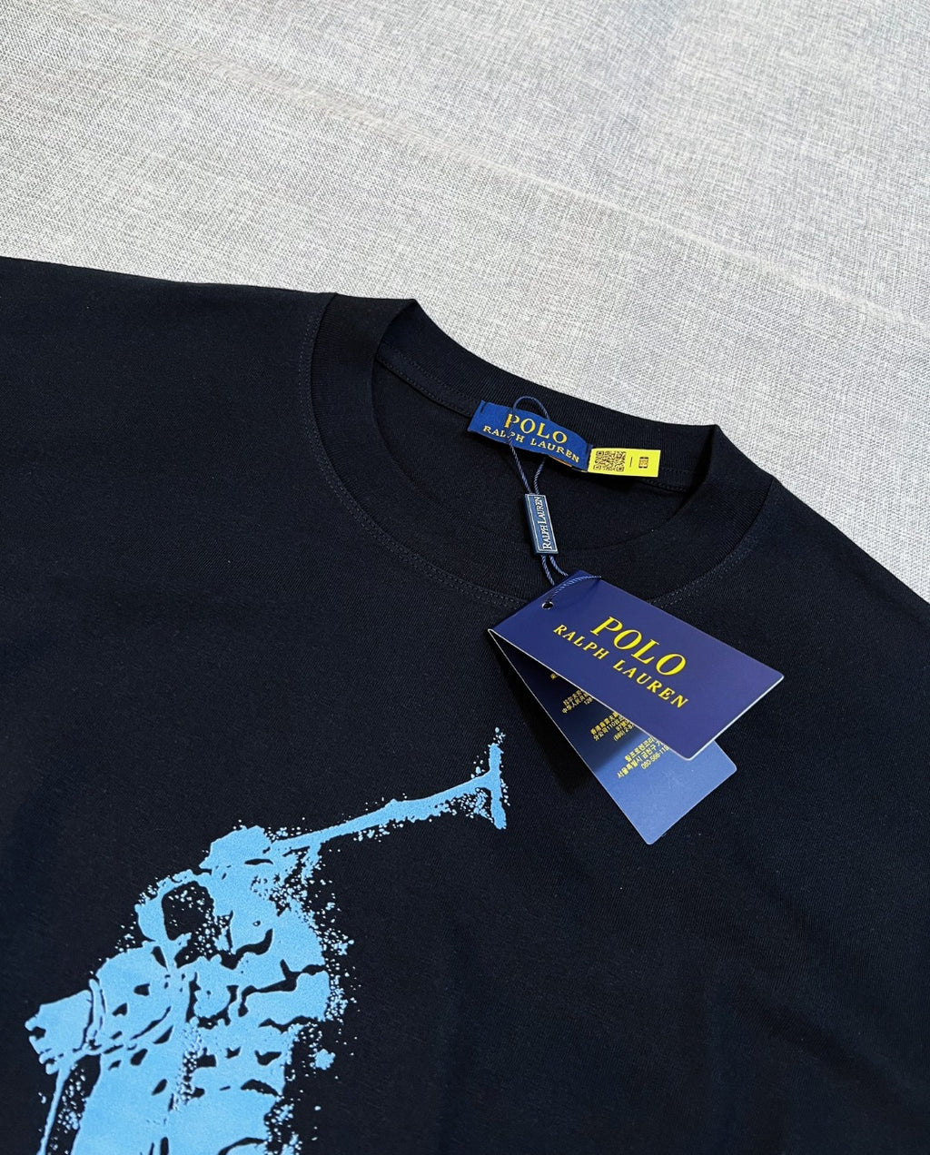 Polo Ralph Lauren black T-shirt neckline with woven brand tag and blue graphic