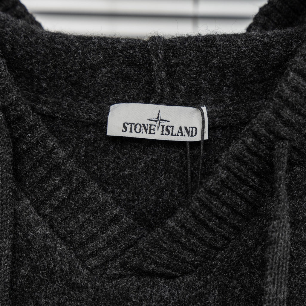 Stone Island brand label on dark charcoal knit hooded sweater