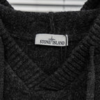 Stone Island brand label on dark charcoal knit hooded sweater